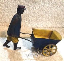 Antique Black Americana Wind Up Toy Man Pushing Cart By Strauss Original Paint