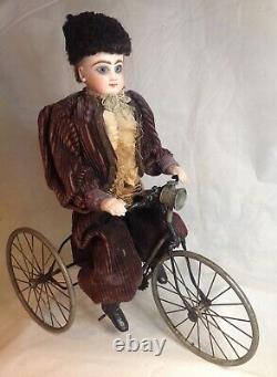 Antique French F. G. Wind Up Mechanical Doll riding Tricycle