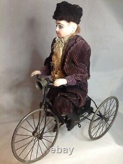 Antique French F. G. Wind Up Mechanical Doll riding Tricycle