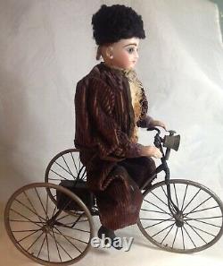 Antique French F. G. Wind Up Mechanical Doll riding Tricycle