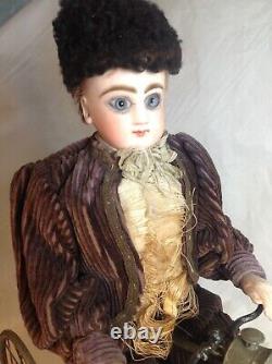 Antique French F. G. Wind Up Mechanical Doll riding Tricycle