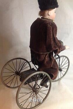 Antique French F. G. Wind Up Mechanical Doll riding Tricycle