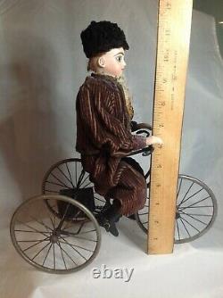 Antique French F. G. Wind Up Mechanical Doll riding Tricycle