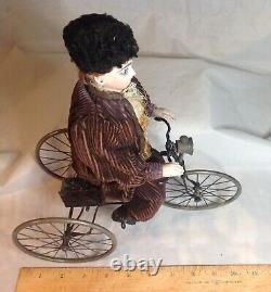 Antique French F. G. Wind Up Mechanical Doll riding Tricycle