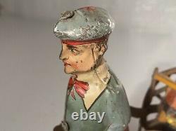 C. 1920 German Issmayer Tin windup Boy pulling Girl in Cart Tin Toy