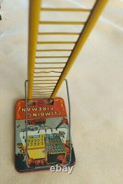 Louis Marx & Co. Smokey Joe climbing firefighter vintage wind up tin toy