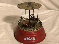 MUSICAL CAROUSEL Hand Painted Tin and Lead Clockwork Toy Early German Guntherman