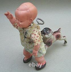 Vintage Celluloid Boy with Bull Dog bitting his behind Wind up Made in Japan
