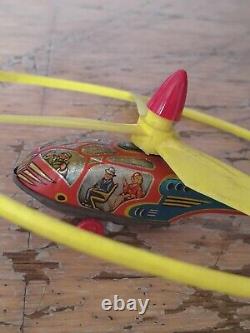 Vintage rustic tin toy hotel with wind up helicopter, made in western germany